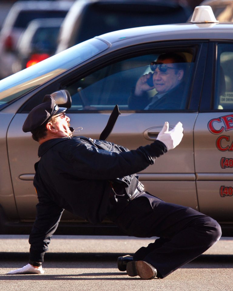   In this Dec. 13, 2012 photo former Providence Police Department office Tony Lepore directs traffic at an intersection on Dorrance Street in Providence, RI. Lepore is know as the dancing cop because of his energetic and rhythmic style of moving vehicles and pedestrians through an intersection. (AP Photo/Stephan Savoia)  