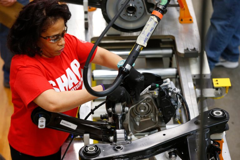 In this March 14, 2014 photo, an assembly line worker builds a 2015 Chrysler 200 automobile at the Sterling Heights Assembly Plant in Sterling Heights, Mich. The Commerce Department releases factory orders for May on Wednesday, July 2, 2014.  (AP Photo/Paul Sancya)
