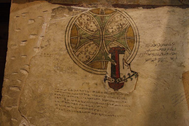 In this Tuesday, April 16, 2013 photo, a detail of layers of frescos dating back to the thirteenth century, and before, at the ancient monastery of St. Anthony southeast of Cairo, Egypt. In a cave high in the desert mountains of eastern Egypt, the man said to be the father of monasticism took refuge from the temptations of the world some 17 centuries ago. The monks at the St. Anthony's Monastery bearing his name continue the ascetic tradition. But even they are not untouched by the turbulent times facing Egypt's Christians, defiantly vowing their community's voice won't be silenced amid Islamists' rising power. (AP Photo/Manoocher Deghati)
