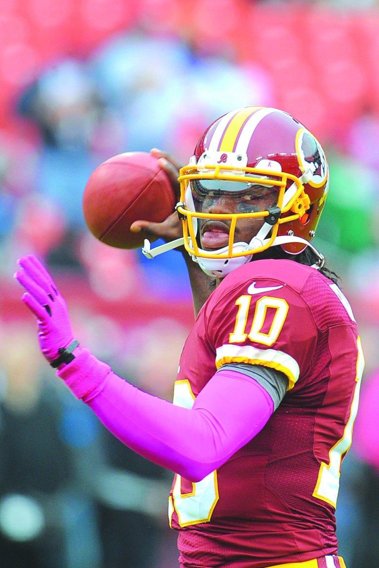 Richard Lipski/AP
Robert Griffin III is not showing any symptoms of his concussion, according to Redskins coach Mike Shanahan.