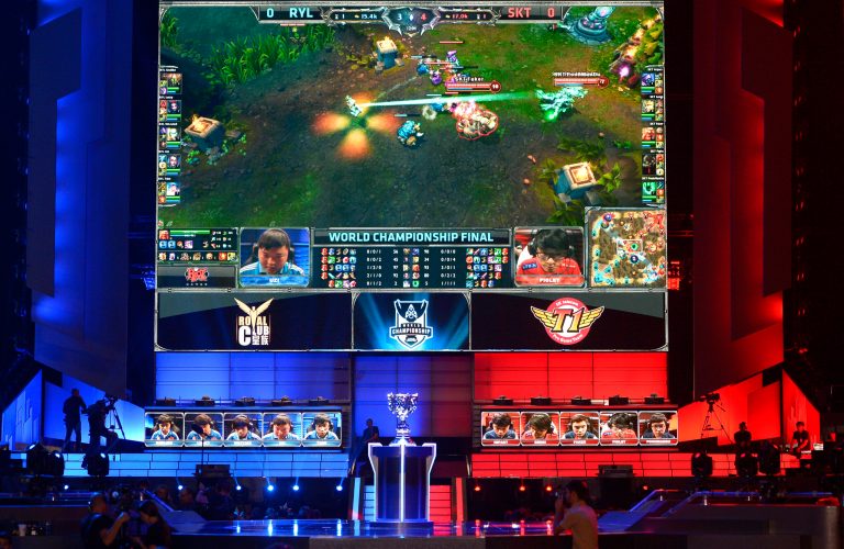 FILE - In this Oct. 4, 2013, file photo, the teams of China's Royal Club, left, and South Korea's SK Telecom T1 compete at the League of Legends Season 3 World Championship Final in Los Angeles. Robert Morris University Illinois, a small private university in Chicago, is offering hefty scholarships for players of League of Legends, which has become one of the most popular games for organized team competitions. The university said it recognizes the growing legitimacy of what are known as 