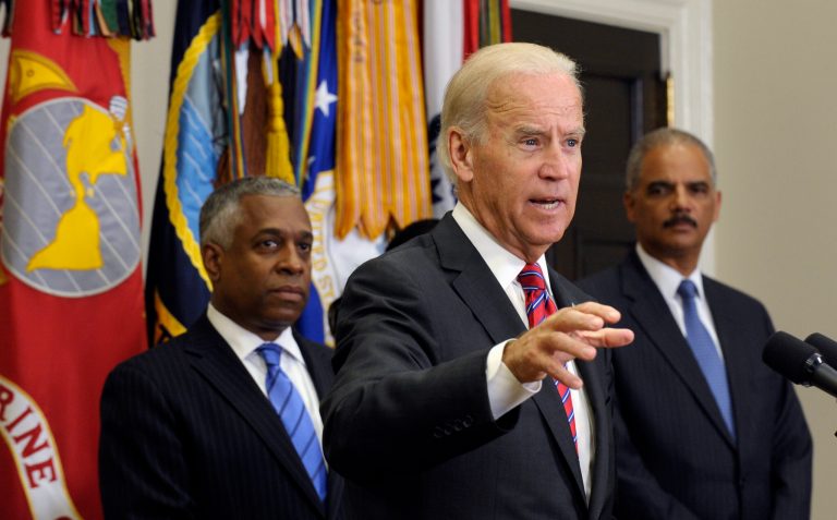   Vice President Biden, center, flanked by Bureau of Alcohol, Tobacco, and Firearms (ATF) Director Todd Jones, left, and Attorney General Eric Holder, speaks in the Roosevelt Room of the White House in Washington, Thursday, Aug. 29, 2013, after the ceremonial swearing-in for Jones. (AP Photo/Susan Walsh)  