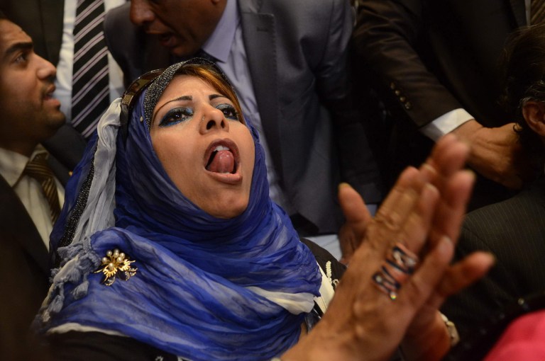 A supporter of Egypt's former military chief Abdel-Fattah el-Sissi reacts to the official announcement declaring him the next president of Egypt with 96.9 percent of the vote, and a turnout of 47.45 percent, at the Election Commission headquarters in Cairo, Egypt, Tuesday, June 3, 2014. El-Sissi's victory was never in doubt, but the career infantry officer had pushed for a massive turnout as well to bestow legitimacy on his ouster last July of Islamist President Mohammed Morsi and the ensuing crackdown on his Muslim Brotherhood and Islamist supporters. (AP Photo/Ahmed Gamil)