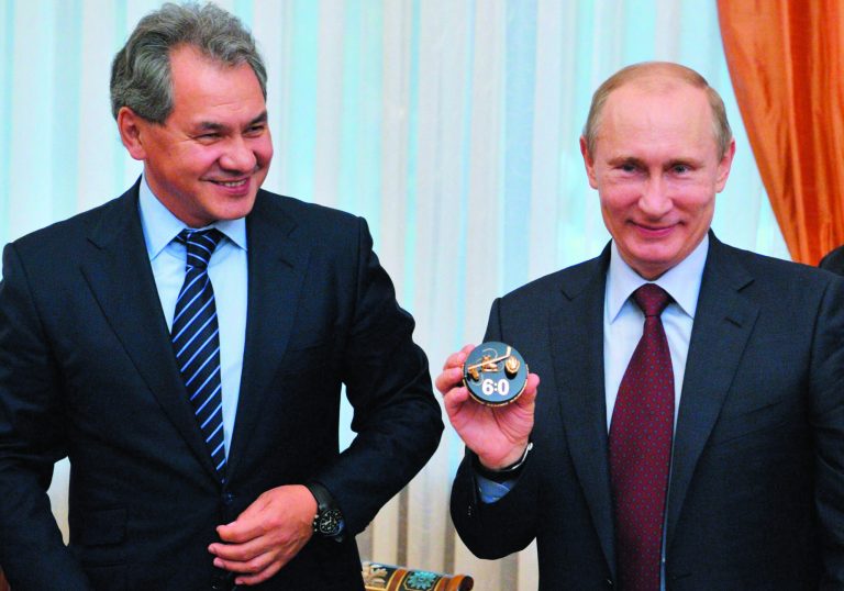 FILE - In this Thursday, Oct. 18, 2012 file photo, Russian President Vladimir Putin, right, flanked by Moscow region Governor Sergei Shoigu, meets with leaders of the Night Hockey League, in the Novo-Ogaryovo residence outside Moscow. Russian President Vladimir Putin has fired the country's defense minister two weeks after a criminal probe was opened into alleged fraud in the sell-off of military assets. Putin made the announcement of Anatoly Serdyukov's dismissal on Tuesday Nov. 6, 2012 in a meeting with Moscow regional governor Sergei Shoigu, whom he appointed as the new minister. (AP Photo/RIA-Novosti, Alexei Nikolsky, Presidential Press Service, file)