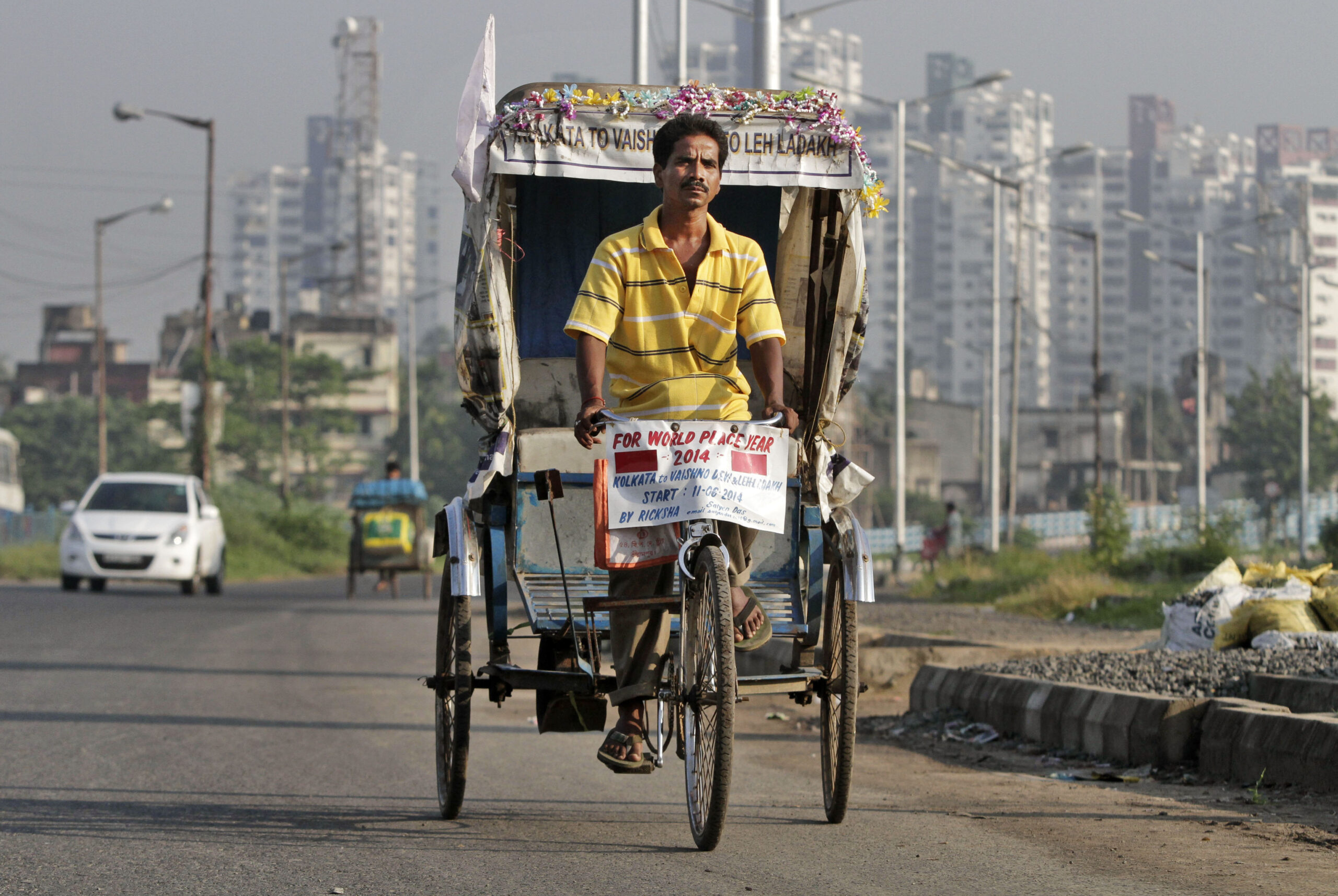 Indian man pedals cycle rickshaw to Himalayan pass