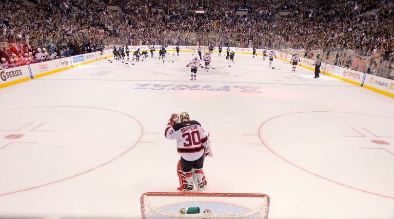   New Jersey Devils goalie Martin Brodeur (30) skates off the ice at the end of the game as the Los Angeles Kings celebrate their 6-1 Stanley Cup win during Game 6 of the NHL hockey Stanley Cup finals, Monday, June 11, 2012, in Los Angeles. (AP Photo/Mark J. Terrill)  