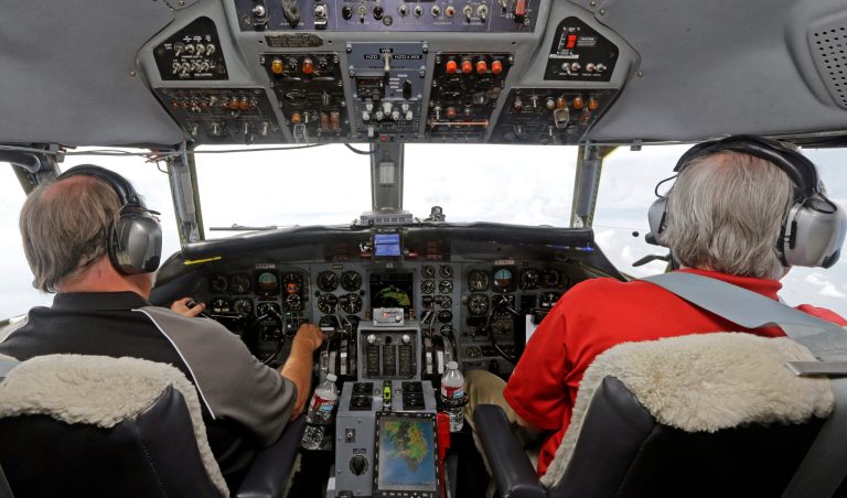 In this Aug. 15, 2014 photo, Captain Randy Moore, left, and co-pilot Mark Johnson, right, fly a Convair 580 test plane during a flight demo of the Honeywell InturVue weather radar over Florida. Advances in radar are helping pilots avoid storms that can injure and upset passengers and even damage planes. (AP Photo/Alan Diaz)
