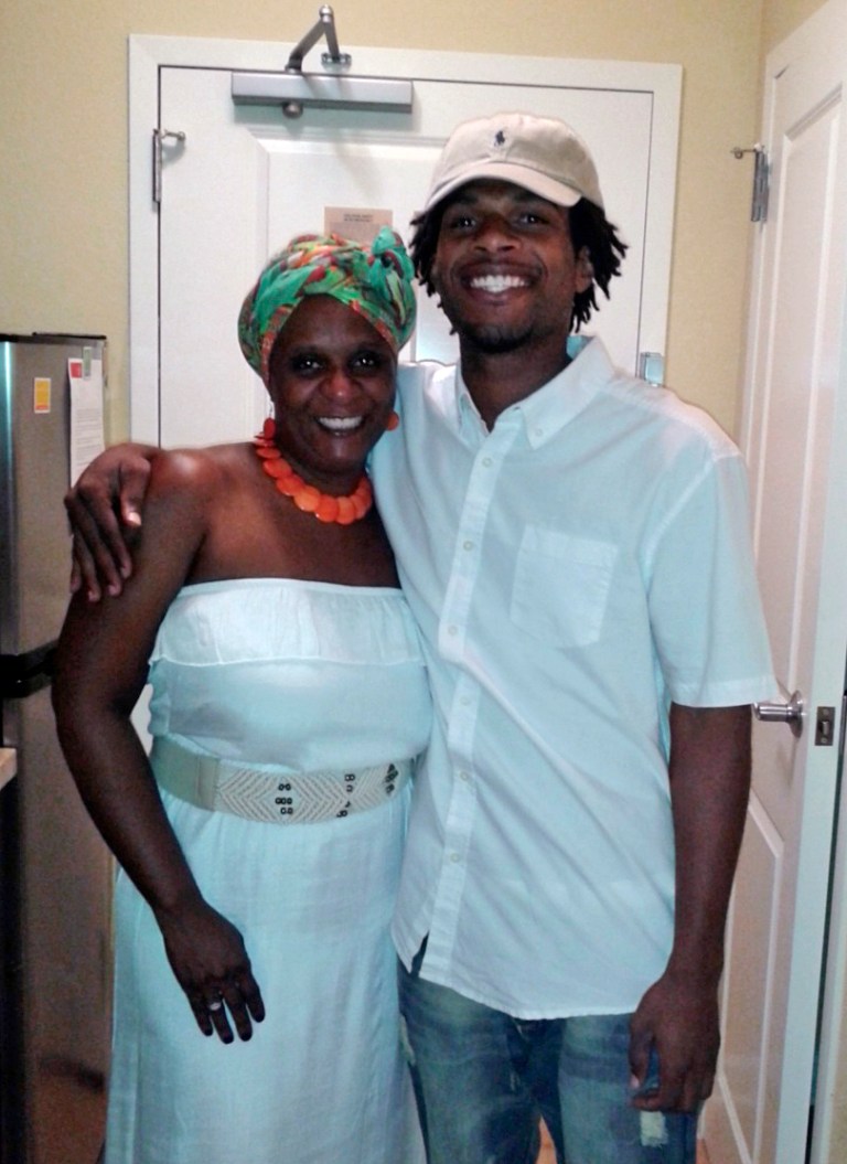 FILE - This undated file photo provided by the family of John Crawford III shows Crawford, right, with his mother, Tressa Sherrod. The family of John Crawford, who was fatally shot by police in an Ohio Wal-Mart, says soundless surveillance video shows their actions were unreasonable. But a prosecutor cited the same video to explain the shooting was justified. (AP Photo/Courtesy family of John Crawford III, File)