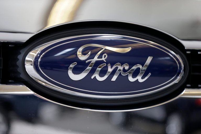FILE - This file photo taken on Feb. 14, 2013 shows the Ford logo on the grill of a 2013 Ford F-350 truck on display at the Pittsburgh Auto Show in Pittsburgh. Ford reports quarterly earnings on Friday, April 25, 2014. (AP Photo/Gene J. Puskar, File)