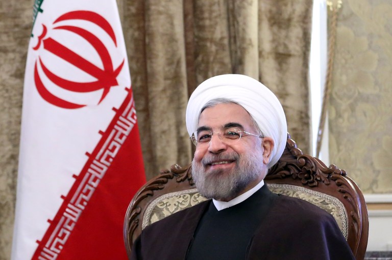 Iranian President Hassan Rouhani smiles during a meeting with Afghan President Hamid Karzai, at Tehran's Saadabad Palace in Iran on Dec. 8. (AP Photo/Ebrahim Noroozi)