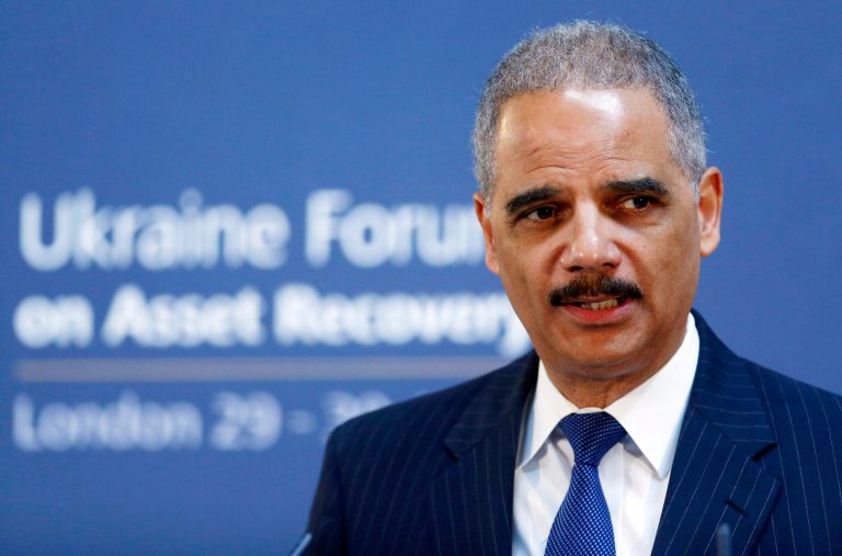 FILE - In this April 29, 2014 file photo, U.S. Attorney General Eric Holder speaks at the Ukraine Forum on Asset Recovery in central London. Holder and other federal law enforcement officials are expected to reveal criminal charges Monday in an international cyber-espionage case on Monday, May 19, 2014, said an official speaking on condition of anonymity because the person was not authorized to discuss the case by name in advance of the announcement. (AP Photo/Andrew Winning, Pool, File)