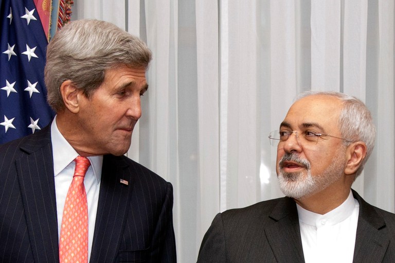 Secretary of State John Kerry, left, listens to Iran's Foreign Minister Mohammad Javad Zarif, right, before resuming talks over Iran's nuclear program. (AP Photo/Brian Snyder)