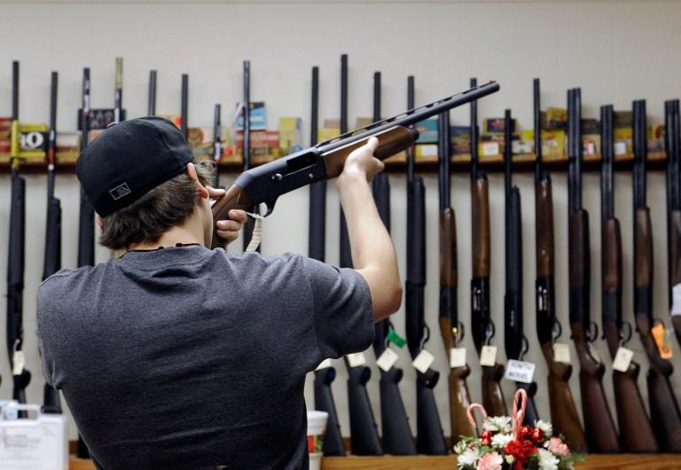   In this photo taken Wednesday, Dec. 19, 2012, a customer checks out a shotgun at Burdett & Son Outdoor Adventure Shop in College Station, Texas. More civilians are armed in the U.S. than anywhere else in the world, with Yemen coming in a distant second, according to the Small Arms Survey in Geneva. (AP Photo/Pat Sullivan)  