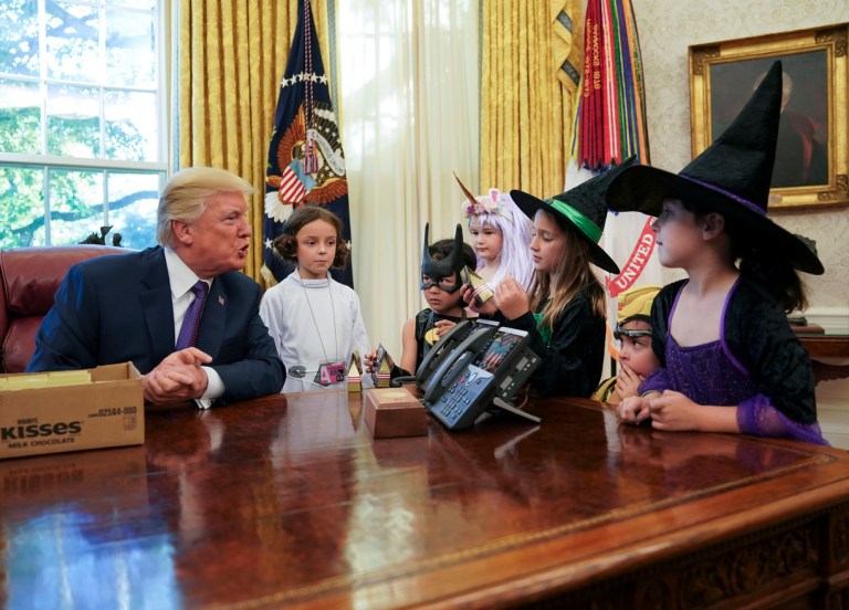 President Donald Trump meets with children dressed in their Halloween costumes in the Oval Office of the White House, Friday, Oct. 27, 2017. The White House had invited the children of members of the media to visit the president and to trick-or-treat at the White House complex of the Eisenhower Executive Office building. (AP Photo/Pablo Martinez Monsivais)