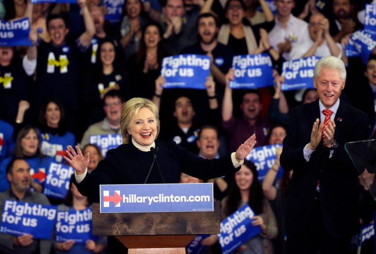 Democratic presidential candidate Hillary Clinton speaks as former President Bill Clinton applauds at her New Hampshire presidential primary campaign rally, Tuesday, Feb. 9, 2016, in Hooksett, N.H. (AP Photo/Elise Amendola)