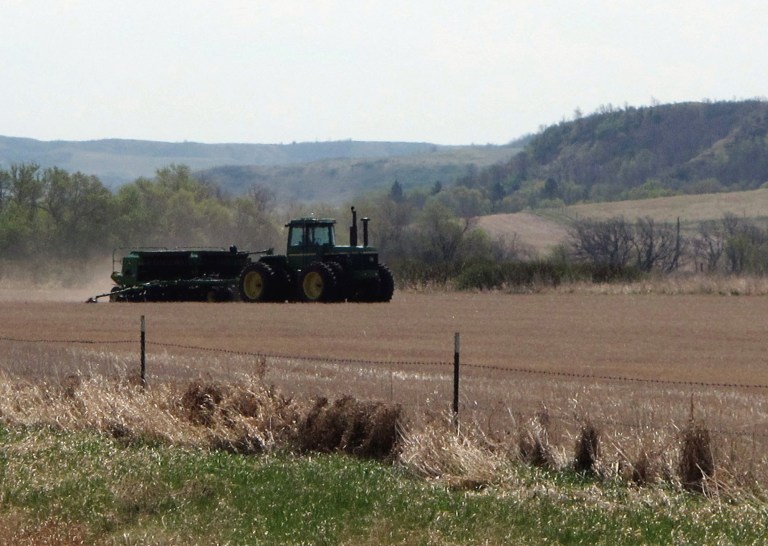 FILE - This April 25, 2012 file photo shows a farmer planting corn in a field near Huff, N.D.  The federal government says it can't meet a request by U.S. Sen. Heidi Heitkamp to extend a crop planting deadline for corn in North Dakota. The U.S. Department of Agriculture's Risk Management Agency says it's prohibited by federal regulations from making a change to the May 25 deadline set for most North Dakota counties. Many corn farmers in the state are having a tough time getting their crop seeded because of a wet spring.  (AP Photo/Dave Kolpack, File)
