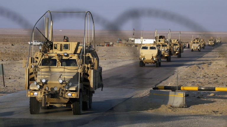 The final section of the last American military convoy to depart Iraq from the 3rd Brigade, 1st Cavalry Division crosses over the border into Kuwait on December 18, 2011 in Khabari Al Awazeem, Kuwait. (Photo by Mario Tama/Getty Images)