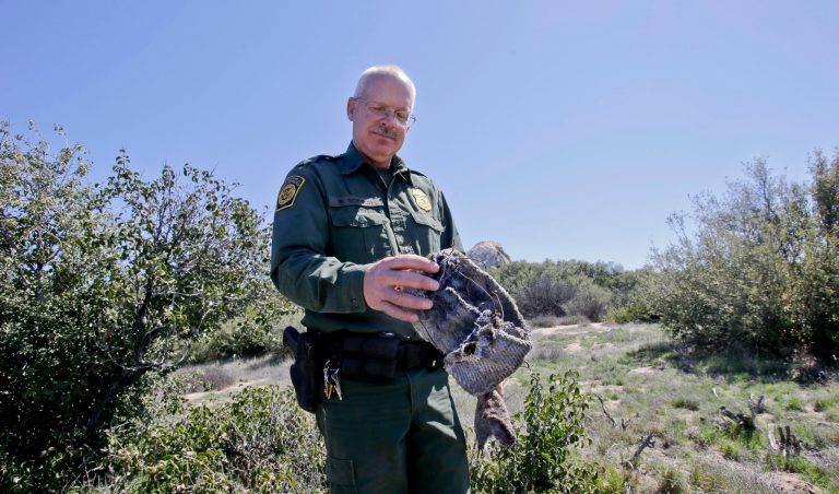 In this Monday, March 25, 2013 photo, Border Patrol agent Richard Gordon, a 23-year veteran of the agency, holds a foot wrap made of carpet and wire which illegal immigrants use to disguise their footprints while trying to avoid being tracked after entering the United States in the Boulevard area east of San Diego in Boulevard, Calif. For the past 16 years Gordon has been one of the top 
