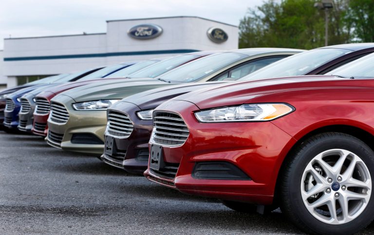 FILE - In this Wednesday, May 8, 2013 file photo, a row of new 2013 Ford Fusions are on display at an automobile dealership in Zelienople, Pa. As the auto industry strives to sustain its post-recession comeback, car companies are resorting to tactics that some experts warn will lead to trouble down the road.  (AP Photo/Keith Srakocic, File)