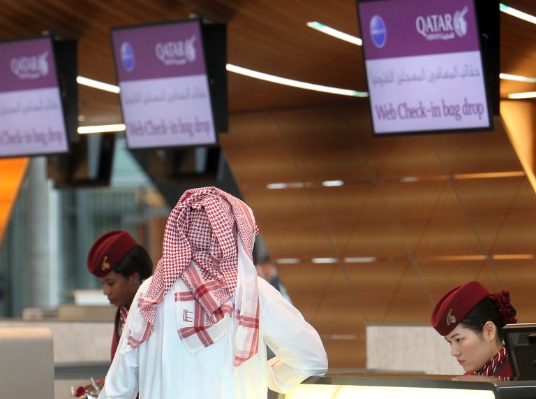 A Qatari passenger completes his travel formalities inside the new Hamad International Airport on the opening day, in Doha, Qatar, Tuesday, May 27, 2014. Qatar Airways has moved all of its operations to a new multi-billion dollar airport in its capital of Doha. The Mideast airline says the move to Hamad International Airport marks 