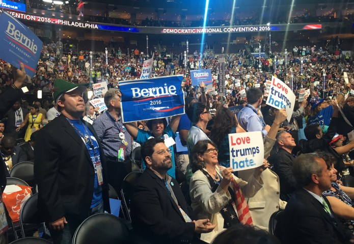 The delegates hoisted signs opposing the Trans-Pacific Partnership trade deal Bernie Sanders opposes as well as signs saying "Love trumps hate." (Philip Klein/Washington Examiner)