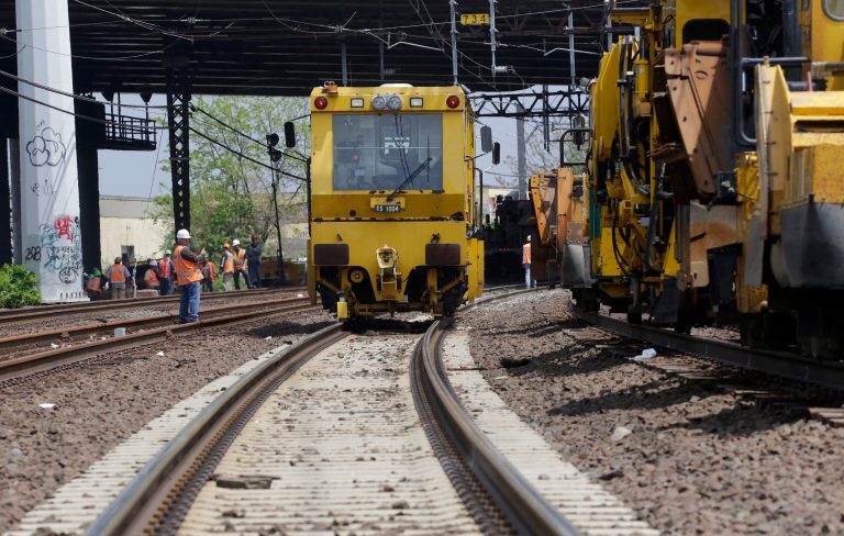Metro North railroad employees use heavy equipment to repair tracks near Bridgeport, Conn., Monday, May 20, 2013. A train collision on Friday injured 72 people and disrupted rail service into New York City. (AP Photo/Mark Lennihan)