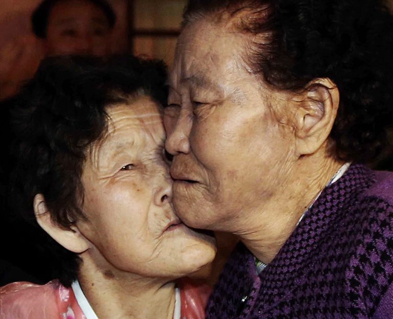 South Korean Lee Chun Hwa, right, gets a kiss from her North Korean sister Lee Chun Son before returning home after a separated family reunion meeting at the Diamond Mountain resort in North Korea, Saturday, Feb. 22, 2014. Elderly North and South Koreans separated for six decades were tearfully reuniting, grateful to embrace children, brothers, sisters and spouses they had thought they might never see again. (AP Photo/Yonhap, Lee Ji-eun) KOREA OUT