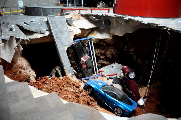 In this Wednesday, Feb. 12, 2014 photo, cars lie in a sinkhole that opened up at the Skydome showroom in the National Corvette Museum in Bowling Green, Ky. The sinkhole that swallowed eight cars at the has become such an attraction that officials want to preserve it. They may even put one or two of the cars back inside the hole. The board of the museum in Kentucky voted Wednesday, June 25, 2014 to preserve a large section of the sinkhole that opened beneath the museum in February. (AP Photo/Michael Noble Jr.)