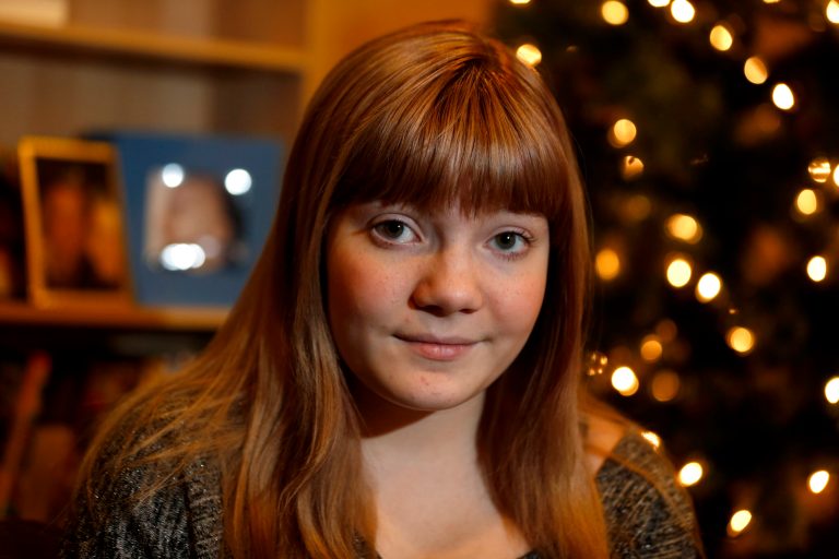   In this Thursday, Dec. 6, 2012 photo, McKenna Pope,13, poses for The Associated Press in her home in Garfield, N.J. Hasbro has announced it has been developing an Easy-Bake Oven in the gender-neutral colors of black and silver. It made the announcement after meeting with Pope, whose online petition asking the company to make one attractive to all kids gathered tens of thousands of signatures. Hasbro says it knows both boys and girls have fun playing with the Easy-Bake. (AP Photo/Julio Cortez)  