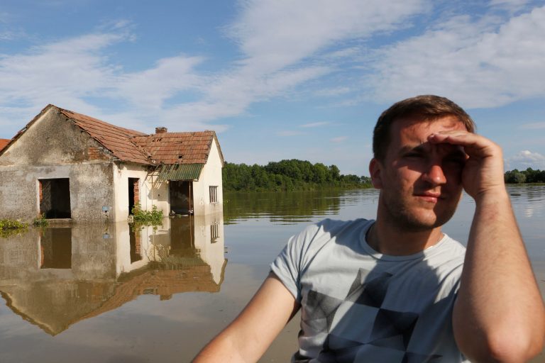 A Bosnian man searches for people and animals after flooding in the village of Vojskova near the Bosnian town of Bosanski Samac, flooded by the river Sava, 200 km's north of the Bosnian capital of Sarajevo, on Monday, May 19, 2014. Tens of thousands evacuated in Serbia and Bosnia during worst floods in a century.(AP Photo/ Amel Emric)