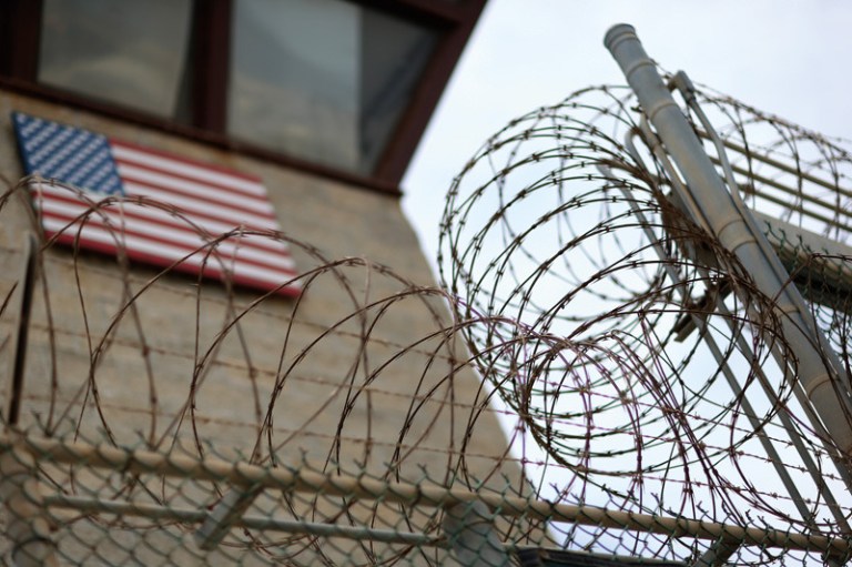 Razor wire tops a fence near the guard tower at the entrance to Camp V and VI at the U.S. military prison for 'enemy combatants' in Guantanamo Bay, Cuba. President Obama has recently spoken again about closing the prison which has been used to hold prisoners from the invasion of Afghanistan and the war on terror since early 2002.  (Photo by Joe Raedle/Getty Images)