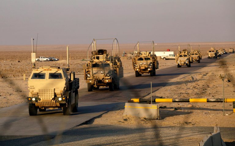 The last convoy of solders from the U.S. Army's 3rd Brigade, 1st Cavalry Division, crosses the border from Iraq into Kuwait, on Dec. 18, 2011. (AP Photo/Maya Alleruzzo)