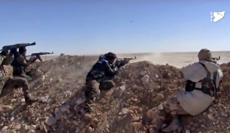 Fighters from the Syria Democratic Forces opening fire on an Islamic State group's position, in Raqqa's eastern countryside, Syria, Monday, March 6, 2017. (Syria Democratic Forces, via AP)