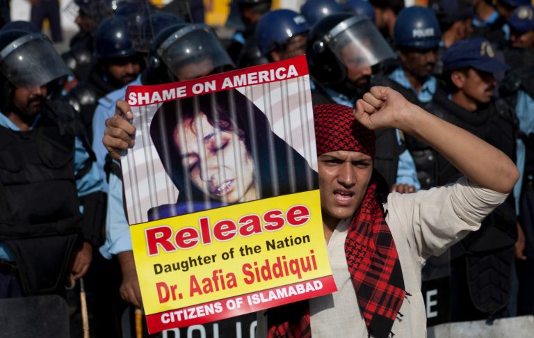 Sept. 24, 2010 - A protester in Islamabad, Pakistan, holds a photo of Aafia Siddiqui, a.k.a. Lady al Qaeda, during a rally condemning her imprisonment. (AP Photo/B.K.Bangash)