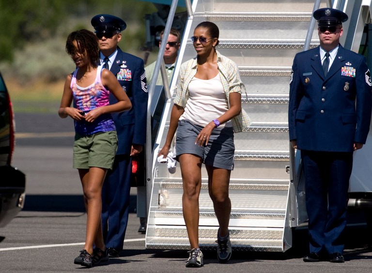 FILE- This his Aug. 16, 2009 file photo shows first lady Michelle Obama, wearing shorts, and daughter Malia Obama, walking off Air Force One at Grand Canyon National Park Airport in Tusayan, Ariz. By now, Michelle Obama has firmly established her sartorial right to bare arms. But baring thighs may be another matter. Photographs of the first lady descending the steps of Air Force One in shorts have the media in a sweat. Some are saying Mrs. Obama _ on her way to the Grand Canyon for a family vacation _ may have revealed too much skin. (AP Photo/Dana Felthauser, File)