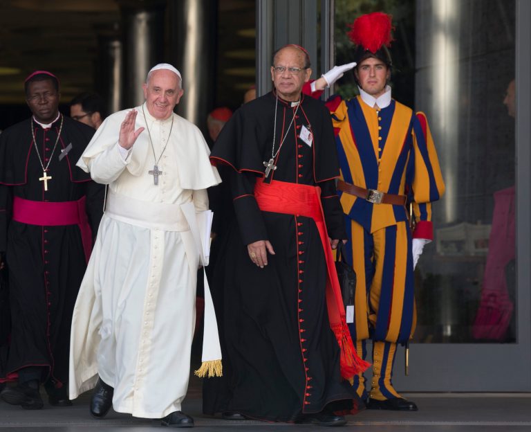 Pope Francis is flanked by Indian Cardinal Oswald Gracias as they leave at the end of the morning session of the Synod on family, a two-week meeting of 200 cardinals and bishops from around the world, at the Vatican, Thursday, Oct. 9, 2014. (AP Photo/Alessandra Tarantino)