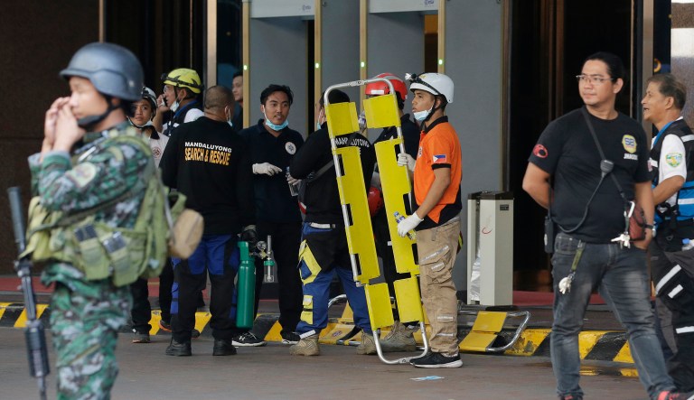 A gunman stormed a mall-casino complex, torched gambling tables and stuffed a backpack with casino chips before fleeing in Manila, Philippines. (AP Photo/Aaron Favila)