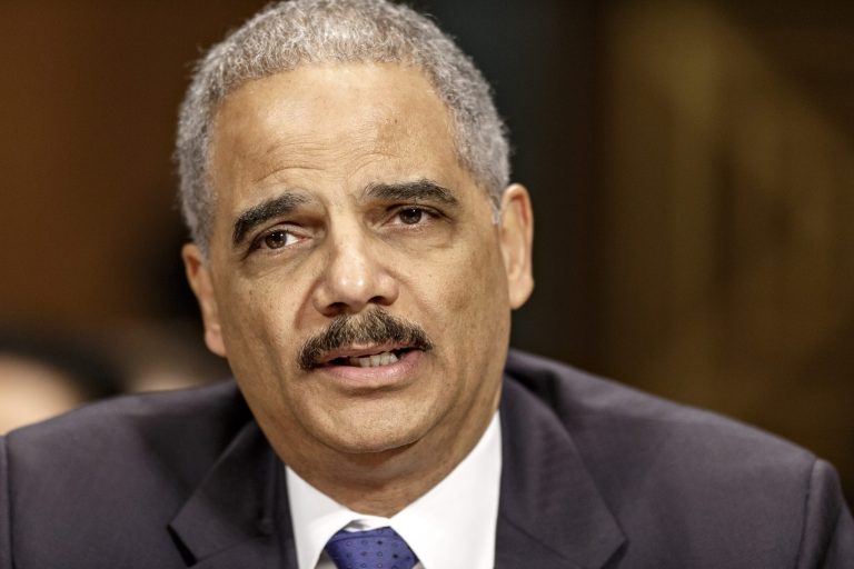 FILE - In this Jan. 29, 2014 file photo, Attorney General Eric Holder testifies on Capitol Hill in Washington. In an assertion of same-sex marriage rights, Holder is applying a landmark Supreme Court ruling to the Justice Department, announcing Saturday that same-sex spouses cannot be compelled to testify against each other, should be eligible to file for bankruptcy jointly and are entitled to the same rights and privileges as federal prison inmates in opposite-sex marriages.  (AP Photo/J. Scott Applewhite, File)