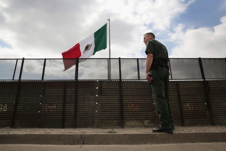Border Patrol agent Jerry Conlin stands on the American side of the U.S.-Mexico border fence on Oct. 3, 2013, at San Ysidro, Calif. (Photo by John Moore/Getty Images)
