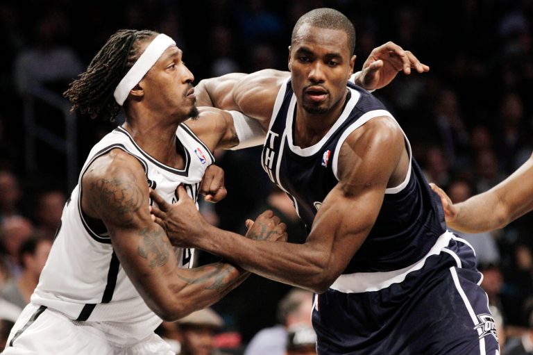   Brooklyn Nets forward Gerald Wallace (45) jostles with Oklahoma City Thunder center Kendrick Perkins (5) on a rebound in the second half of their NBA basketball game at Barclays Center, Tuesday, Dec. 4, 2012, in New York. The Thunder won 117-111. (AP Photo/Kathy Willens)  
