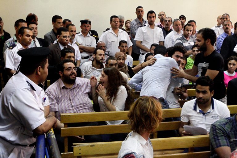 Colleagues and family members react to a court verdict convicting 43 nonprofit workers, including at least 16 Americans, of illegally using foreign funds to foment unrest in the country, sentencing them to up to five years in jail, in Cairo, Egypt, Tuesday, June 4, 2013. Present at Tuesday's hearing was American Robert Becker, who received a two-year sentence. Becker has maintained that his refusal to flee Egypt with fellow Americans who were in the country at the time of the crackdown on nonprofit groups was to show solidarity with his Egyptian colleagues. (AP Photo/Ahmed Abd El Latif, El-Shoruk Newspaper) EGYPT OUT