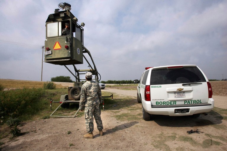 A member of the National Guard checks on his colleague inside a Border Patrol skybox near the Hidalgo International Bridge in Hidalgo, Texas, in 2011. (AP Photo/Delcia Lopez, File)