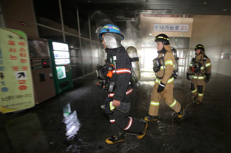 South Korean firefighters arrive at a bus terminal at Goyang, north of Seoul, South Korea, Monday, May 26, 2014. A fire at the bus terminal near Seoul on Monday left seven people dead and 20 others injured, emergency officials said. (AP Photo/Yonhap, Lee Jung-hun) KOREA OUT