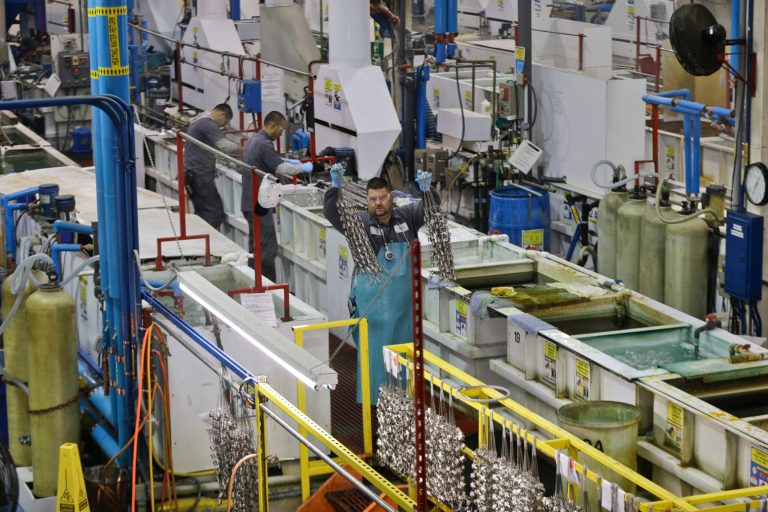 FILE - In this Thursday, Oct. 10, 2013, file photo, employees at Sheffield Platers Inc. work on the factory floor in San Diego. The Institute for Supply Management issues its U.S. manufacturing index for December on Thursday, Jan. 2, 2014 (AP Photo/Lenny Ignelzi, File)