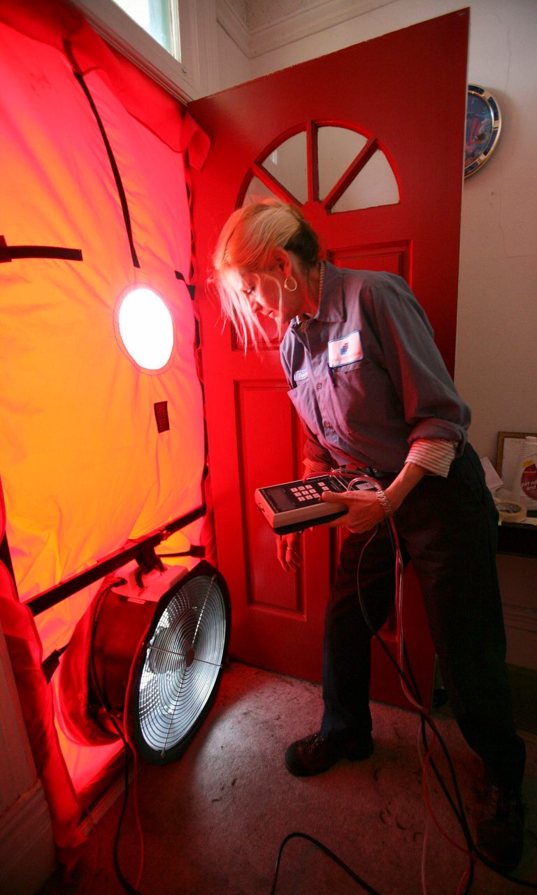 FILE - In this Feb. 26, 2010 file photo, Roseann Mitchell, of the Community Action Agency, checks airflow readings as part of a blower door test assessment in San Francisco. Electricity prices are expected to rise faster this year than they have since 2009, to a record average of 12.5 cents per kilowatt-hour, according to the Energy Department. And prices are highest in the summer, just when you need more power to run the air conditioner. (AP Photo/Ben Margot, File)