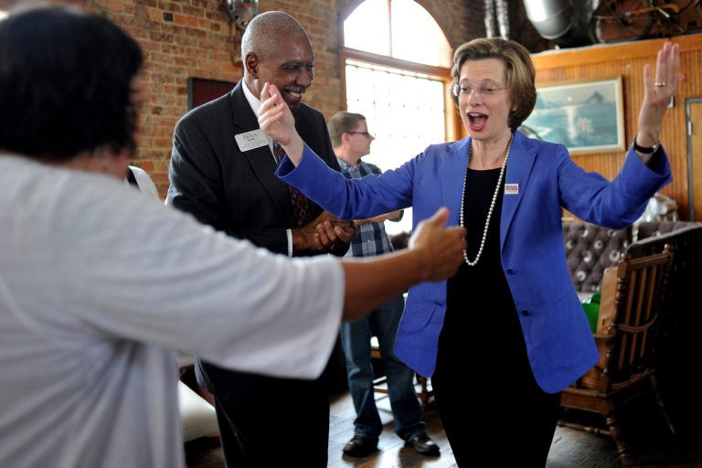U.S. Senate candidate Michelle Nunn, D-Georgia, reacts to seeing friend and supporter Jessica Hunt, left, while U.S. House of Representatives candidate Ken Dious, D-Georgia, stands nearby during a campaign stop at Little Kings Shuffle Club, Wednesday, July 23, 2014, in Athens, Ga. (AP Photo/Athens Banner-Herald, AJ Reynolds)ÃÂ 