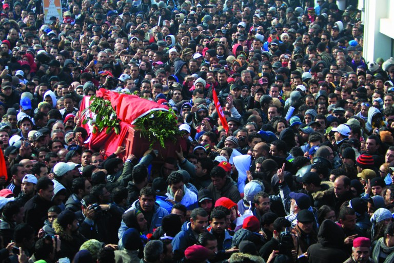 Pallbearers carry the coffin of Chokri Belaid as thousands of Tunisians are gathered at el Jallez cemetary to attend the funerals of the slain opposition leader, near Tunis, Friday, Feb. 8, 2013. The Wednesday Feb. 6 assassination of prominent government critic Belaid plunged the country into one of its deepest political crises since the overthrow of the dictatorship in 2011. Watching the events in Tunisia, where a leading anti-Islamist politician was recently assassinated, members of Egypt's liberal opposition are fearfully asking, Could it happen here too? There are reasons for concern: hardline clerics have called for the killing of opposition leaders, and activists say there are worrying signs that show the ruling Islamists are targeting their ranks _ disappearances of activists from protests and telephone death threats. With Islamists convinced the opposition is trying to overthrow President Mohammed Morsi, there is fertile ground for violence. (AP Photo/Str)