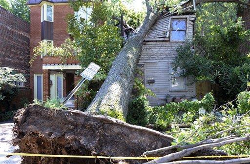 A downed tree crushes an old home on Dent Pl., NW in the Georgetown section of Washington, Sunday, Aug. 28, 2011, brought down by rain and wind from Hurricane Irene. (AP Photo/Cliff Owen)