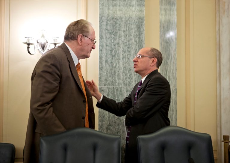   Sen. Jay Rockefeller, D-W.Va., left, and Federal Trade Commission Chairman Jon Leibowitz, right, confer at the start of a meeting on the new Children's Online Privacy Protection Act, COPPA, which regulates Internet websites that collect information from children under the age of thirteen, on Capitol Hill in Washington, Wednesday, Dec. 19, 2012. (AP Photo/J. Scott Applewhite)  