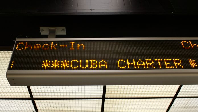 3ff8bbcddb6917fa995ae347ae530a7a.jpg A check-in sign for the ABC Charter flight to Cuba is seen at Miami International Airport on April 7, 2009 in Miami, Florida. (Photo by Joe Raedle/Getty images File)